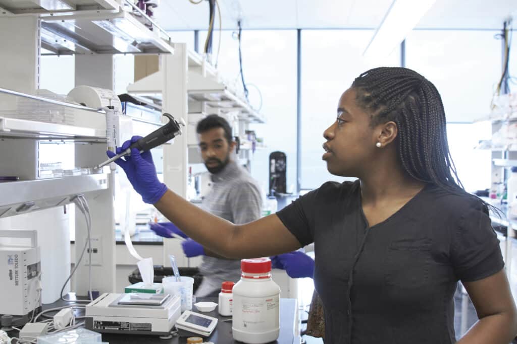 Joel S. Arackal, Sreemathi Palanisamy, and Kia Barclay working on their postdoctoral research.