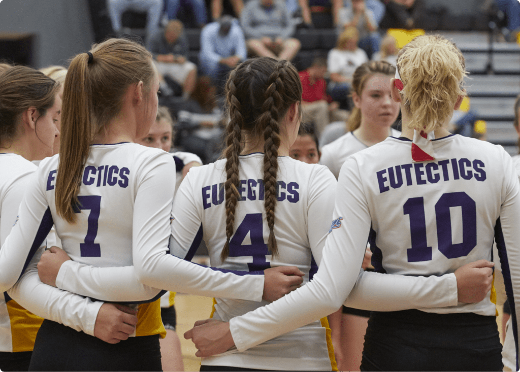 The Eutectic women's volleyball team has a group huddle.