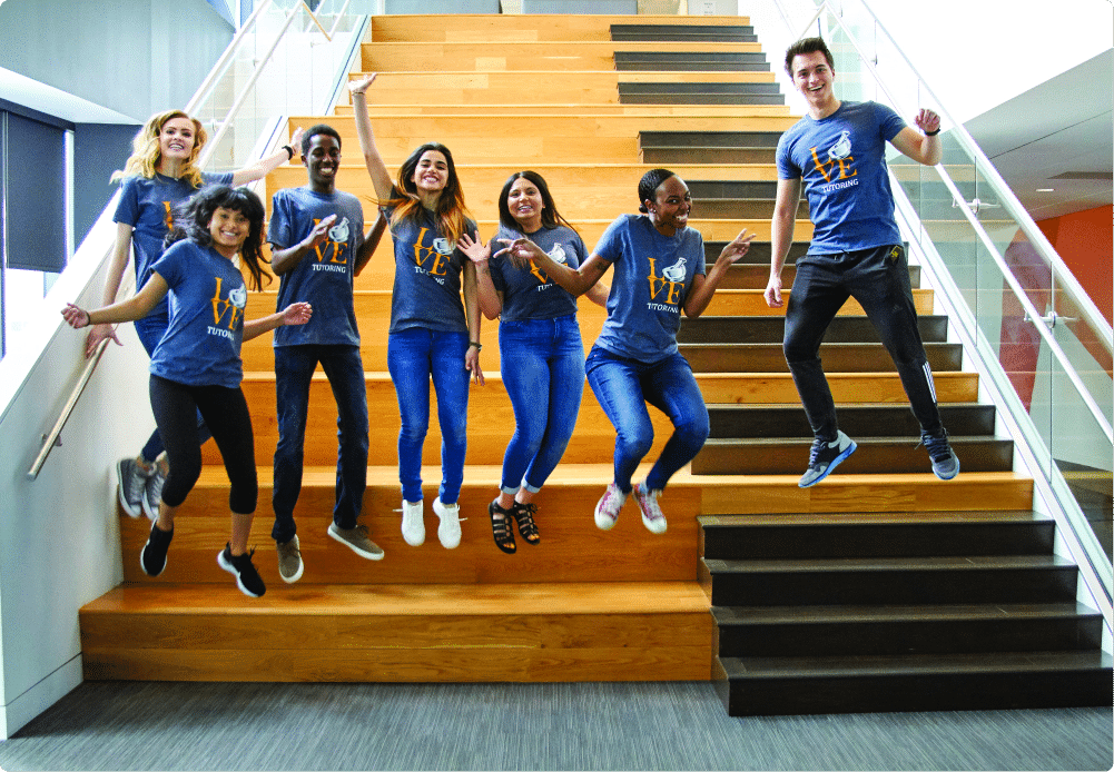 Student leaders jumping on stairs during summer immersion.