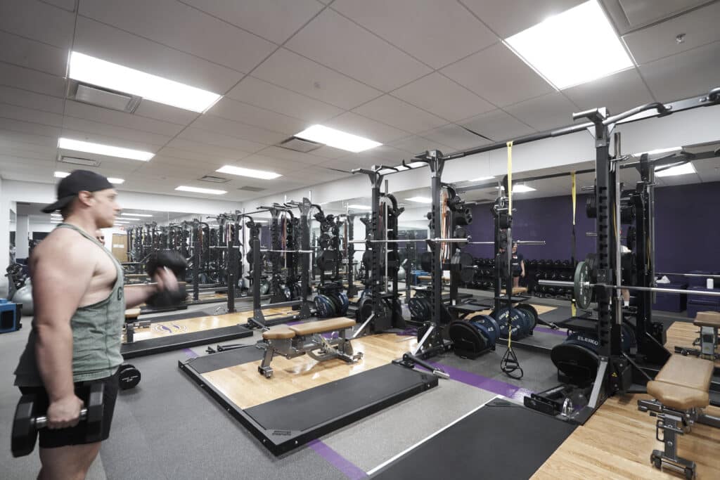 Student athlete lifts weights in the athletics weight room