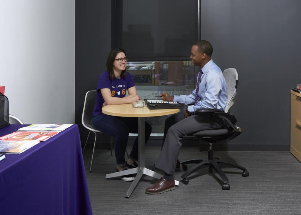 Career center staff member meets with student