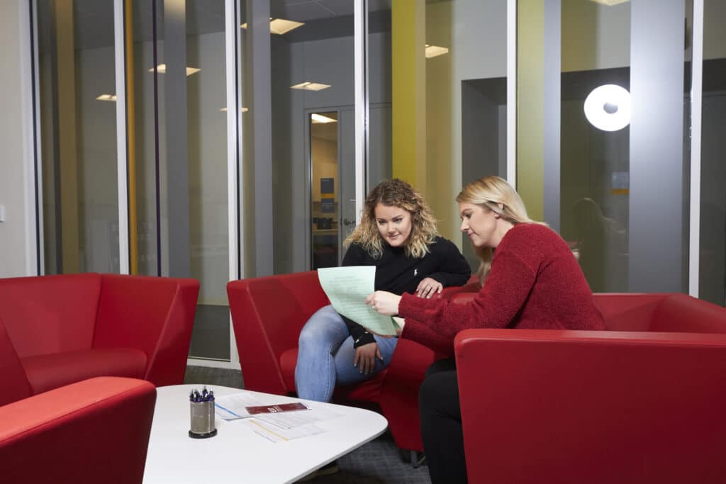 Registrar staff sits with student to course schedule