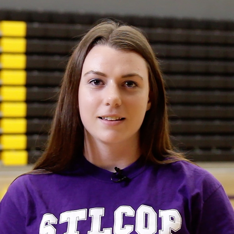 student with brown hair in purple shirt