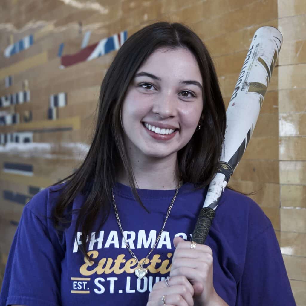 Student athlete Michelle Hollon poses with softball bat held to her shoulder