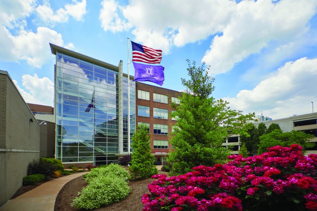 Exterior of Jones Hall from the Quad showing flying American and University Flags