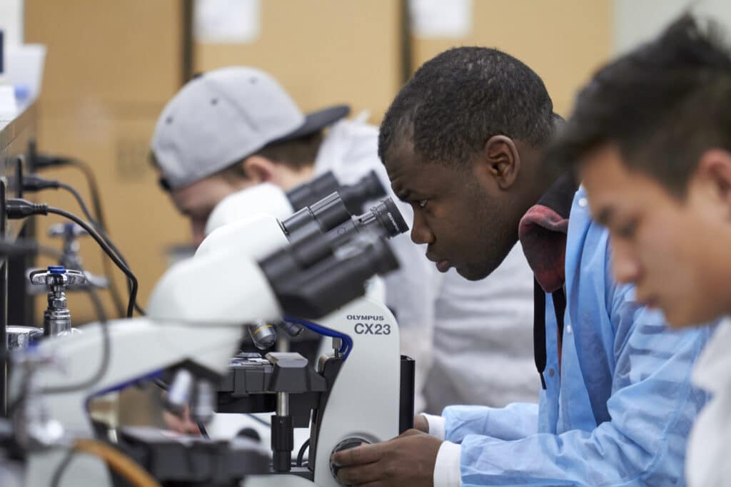 Student looking into a microscope