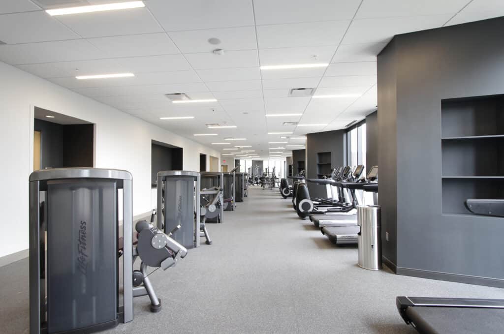 Fitness center hallway showing cardio machines
