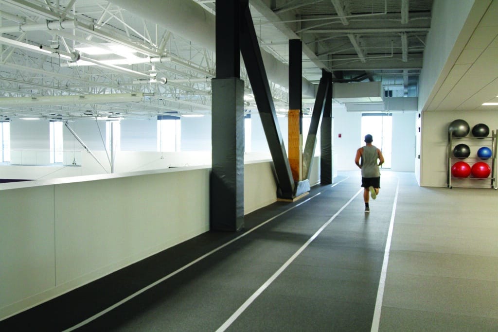 Student running on fitness center track