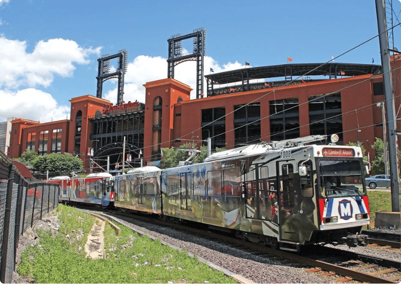 St. louis metro train going past Bush Stadium