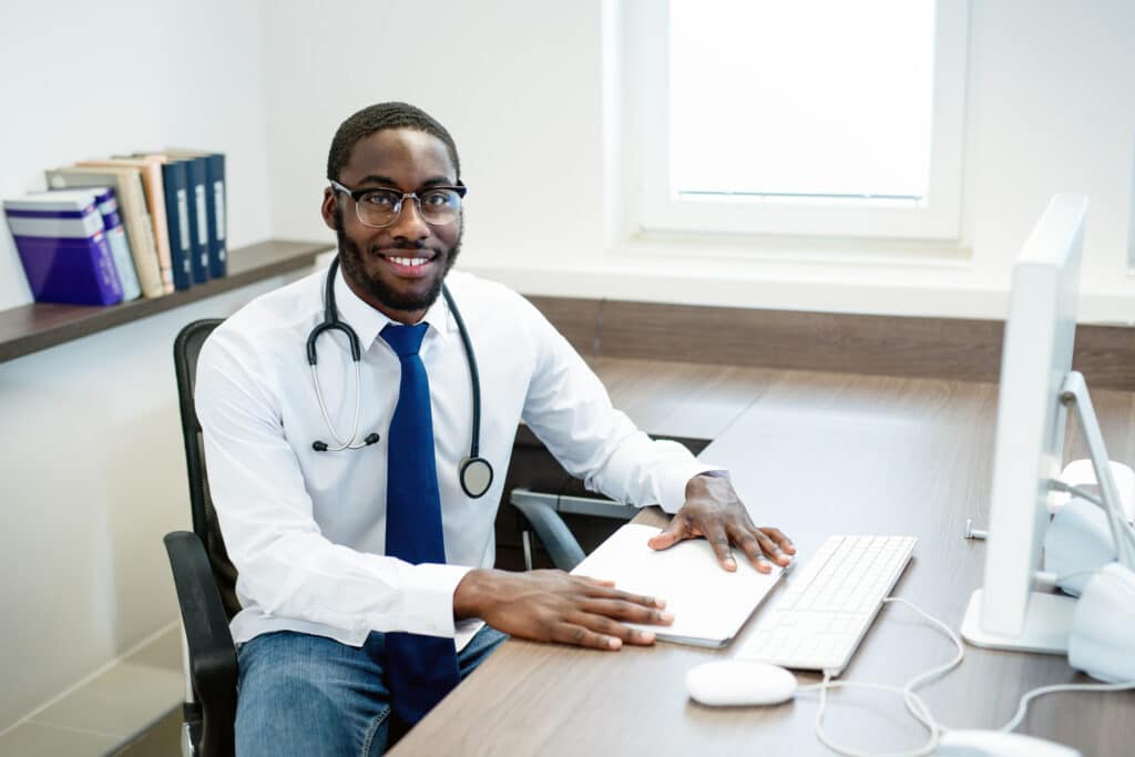 medical student smiles while working at desk