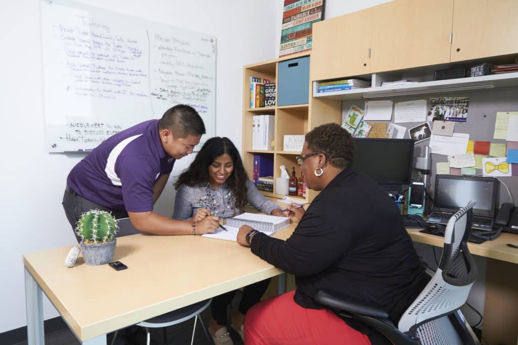 Student success staff assist student in office