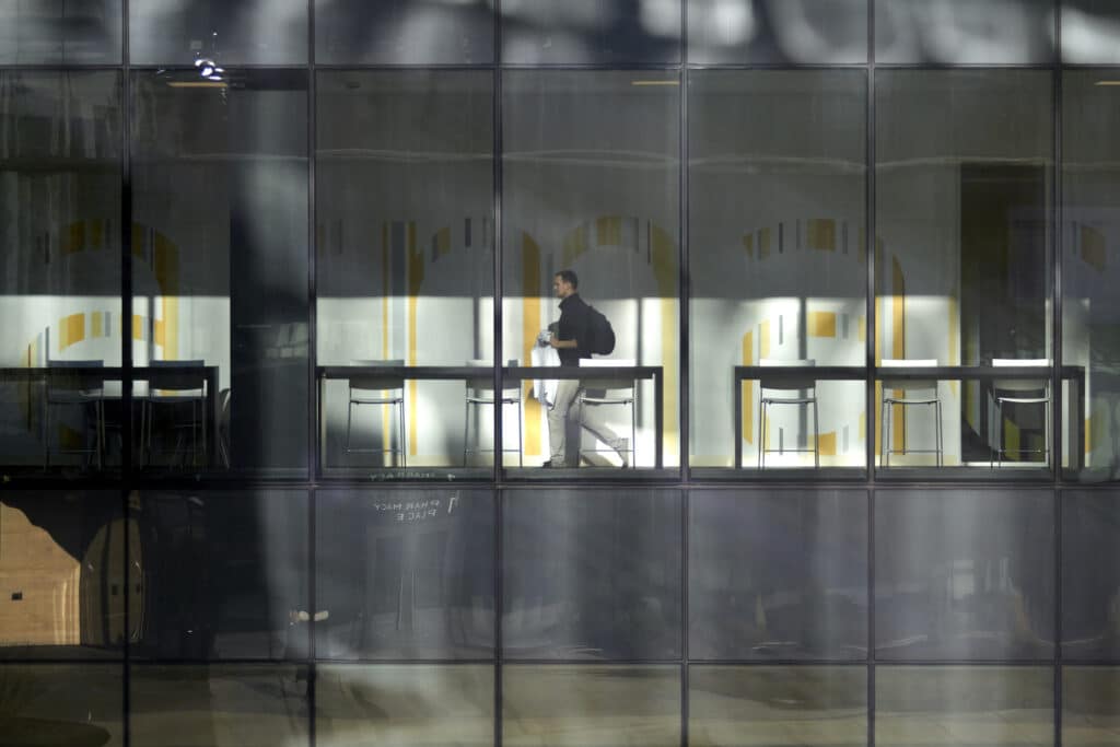 A UHSP student walks through the library in the Academic Research Building