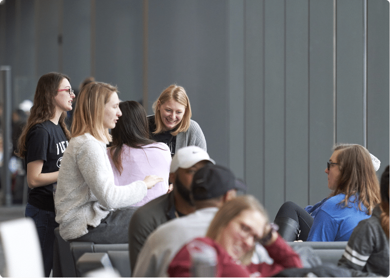 Group of students socialize in ARB lobby.