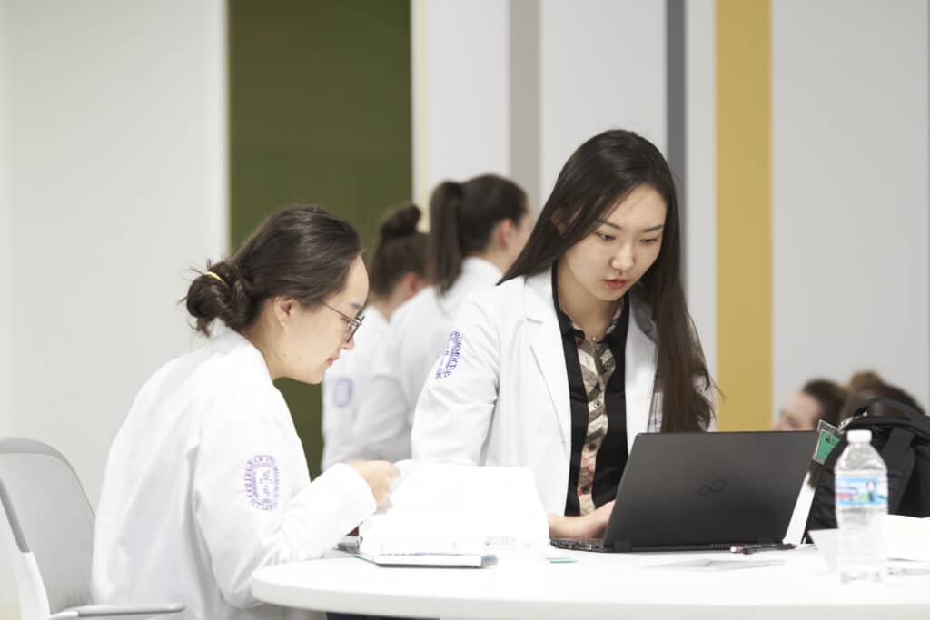 student pharmacists collaborate on a computer