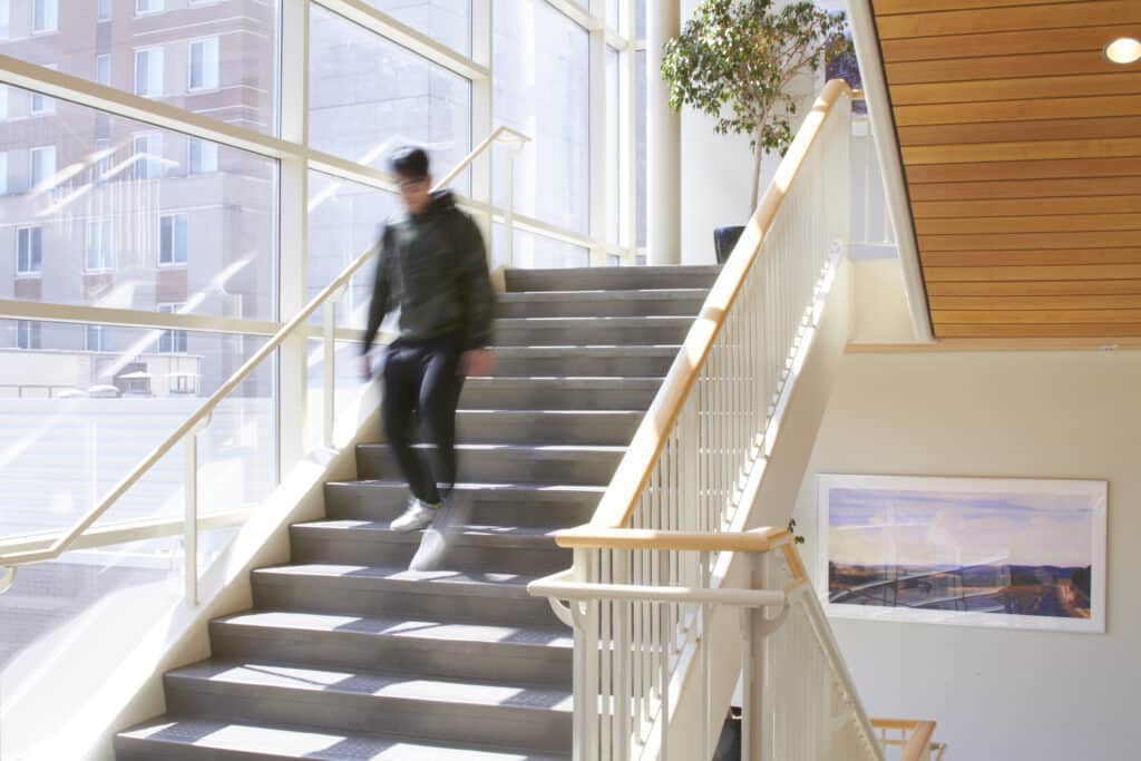 student walking down stairs in Jones Hall