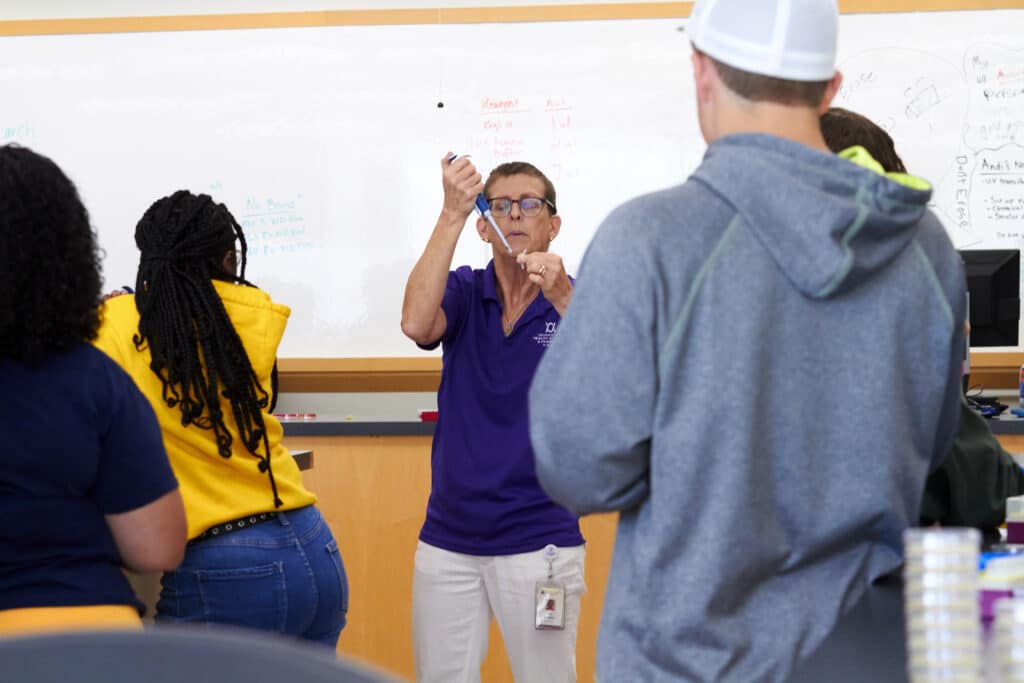 Professor performs demonstration during summer immersion activitiy