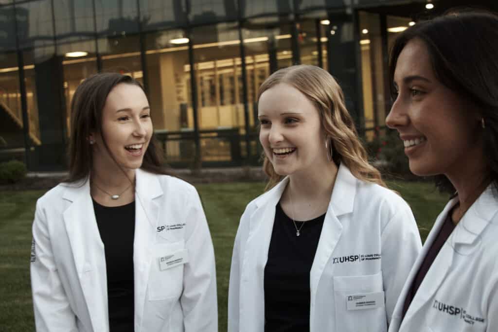 Students celebrating after receiving their white coats.