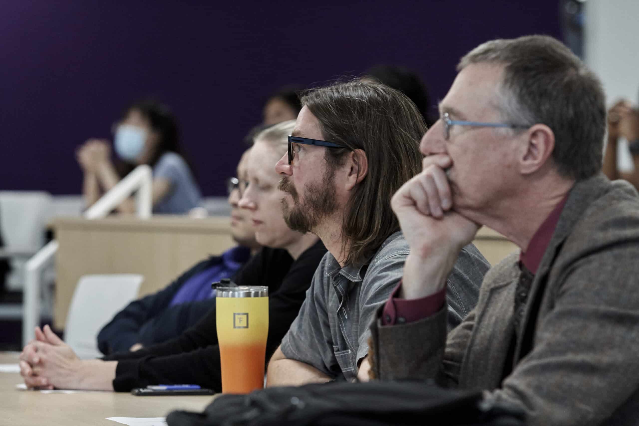 Faculty listen to research presentation