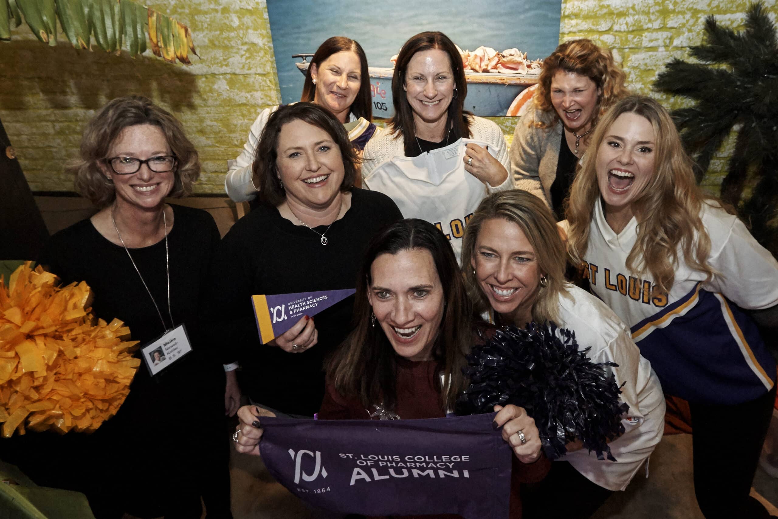 Group of UHSP alumni smile and pose for a photo