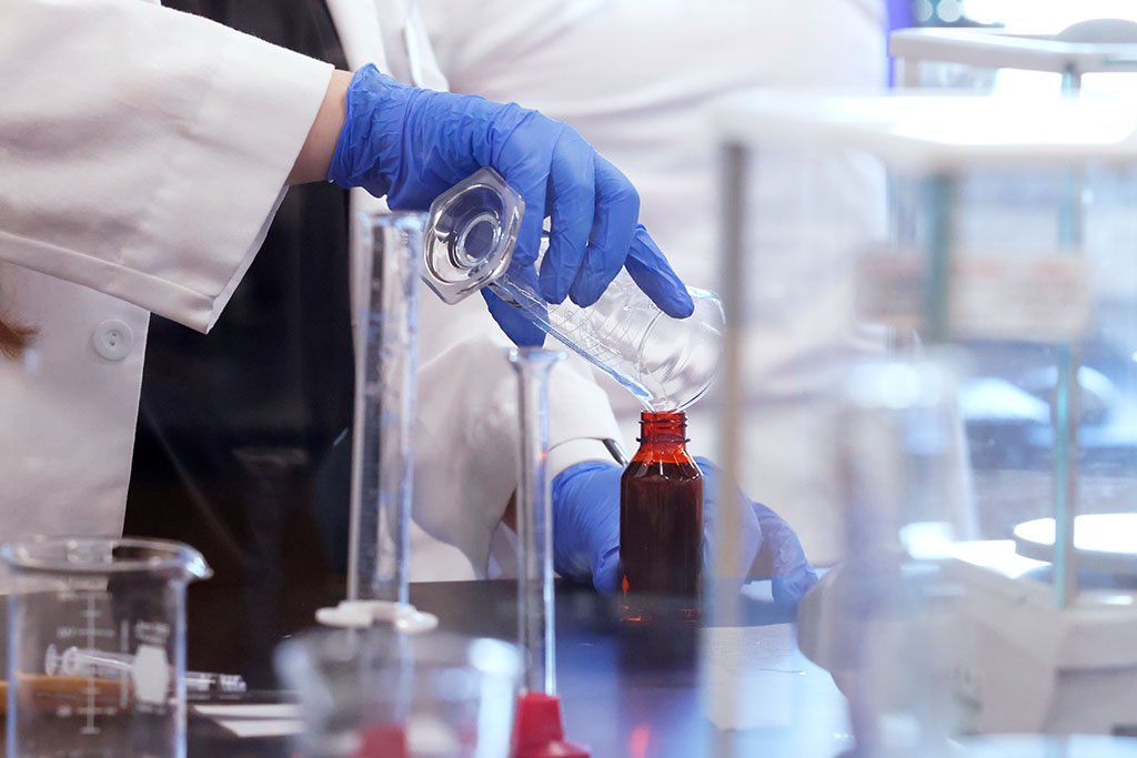 Person in a lab performing an experiment.