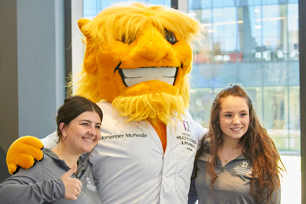 Students pose with Morty for picture.