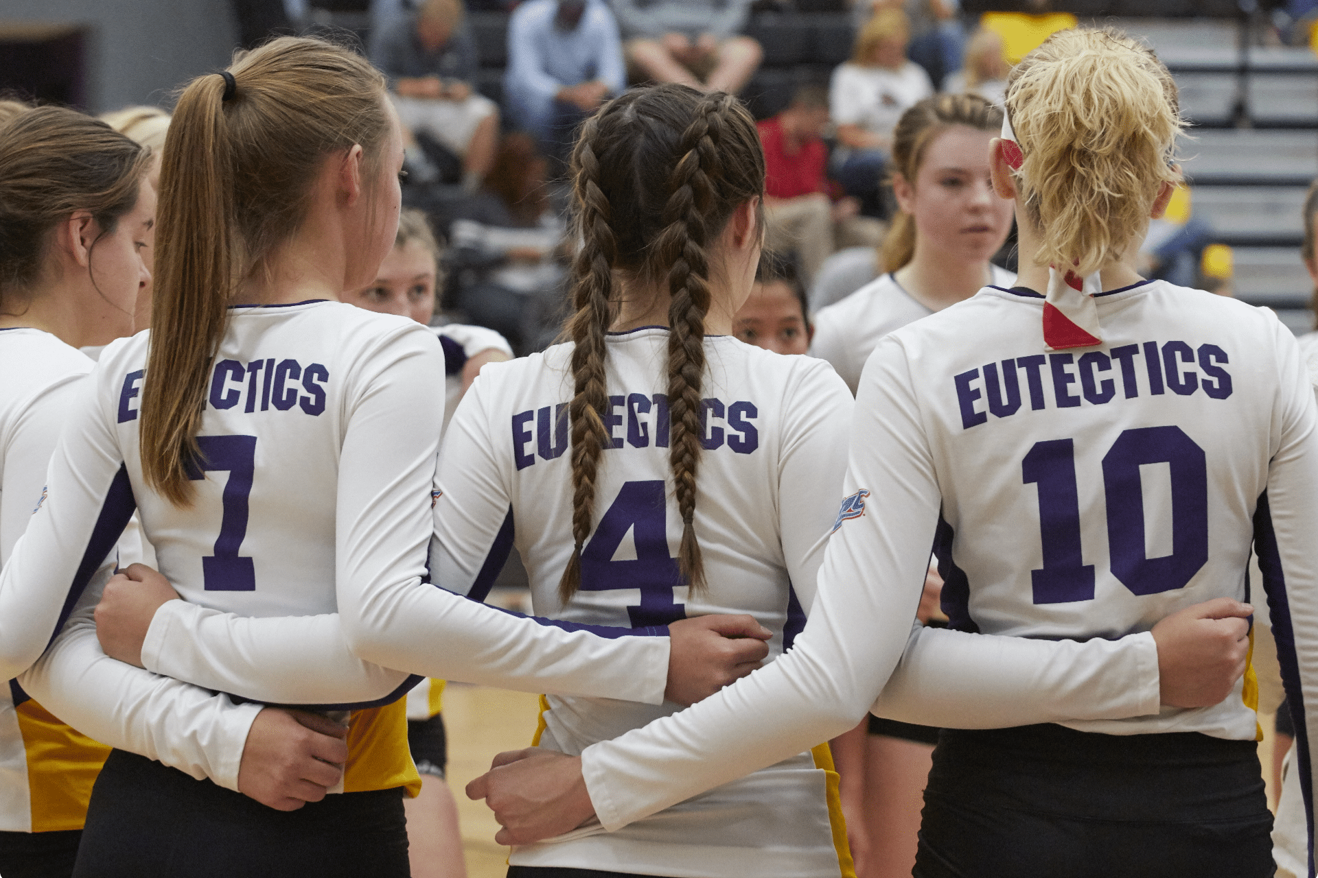 The Eutectic women's volleyball team has a group huddle.